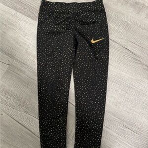 Nike Black and Gold Leggings with Subtle Pattern